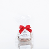 A bag of Black Bow Sweets candied California cinnamon and sugar coated pecans tied with a red bow.