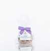 A bag of Black Bow Sweets candied California cinnamon and sugar coated pecans tied with an orchid bow.