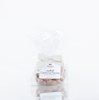 A bag of Black Bow Sweets candied California cinnamon and sugar coated pecans tied with a white bow.