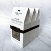 Boxes of Black Bow Sweets candied California cinnamon and sugar coated pecans, almonds, and walnuts tied together with a black bow.