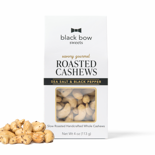 A package of Black Bow Sweets Roasted Cashews (Sea Salt & Black Pepper flavor) shown with a few loose cashews in the foreground on a white background.